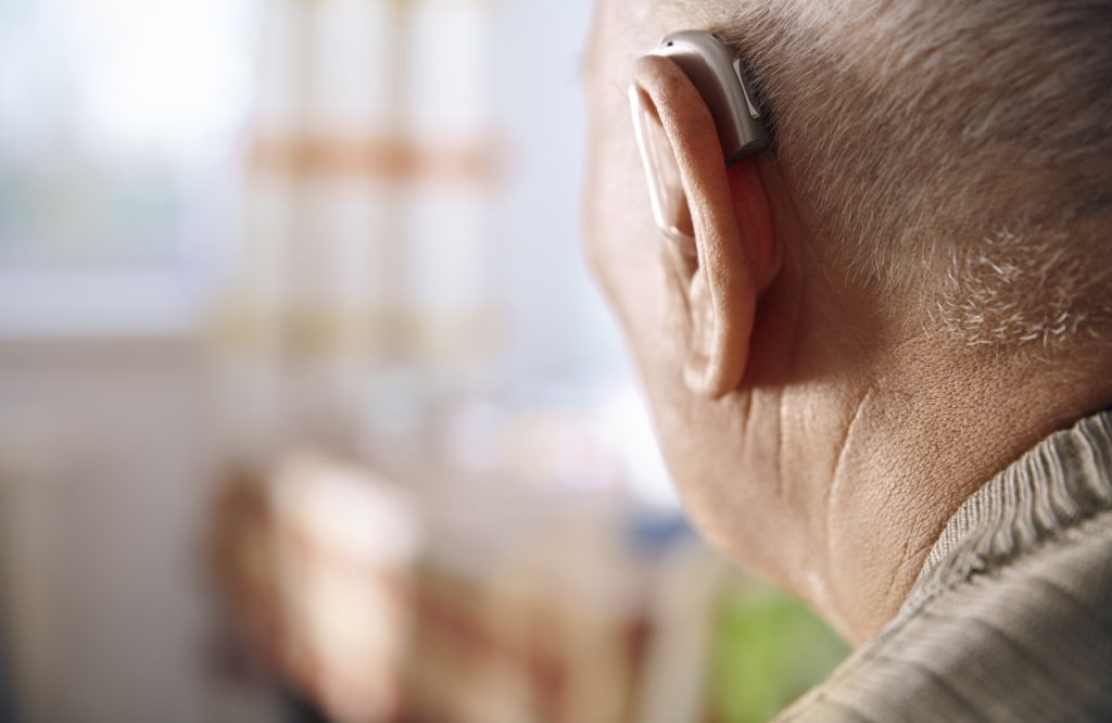 Ear of senior man with hearing aid